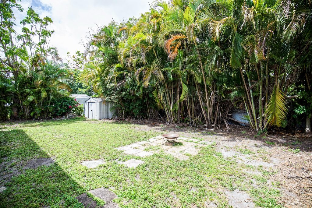 Home Private backyard with mature tropical landscaping at 6445 Funston St